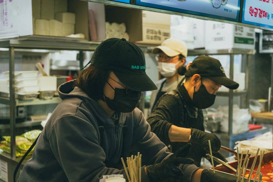 Candid view of street food vendors preparing dishes in Seoul, South Korea.